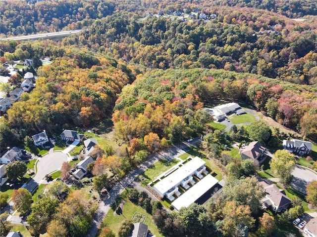 birds eye view of property featuring a wooded view and a residential view