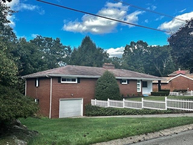 view of side of home featuring a garage and a yard