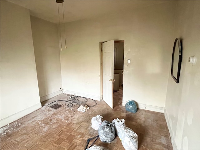 unfurnished room featuring parquet floors