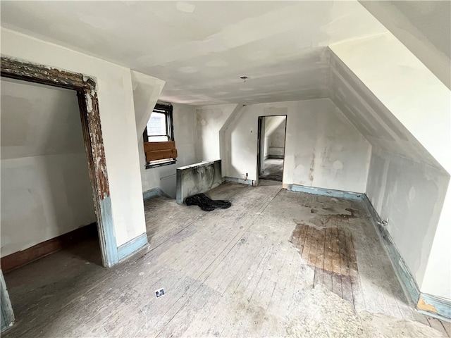 bonus room featuring lofted ceiling and hardwood / wood-style floors