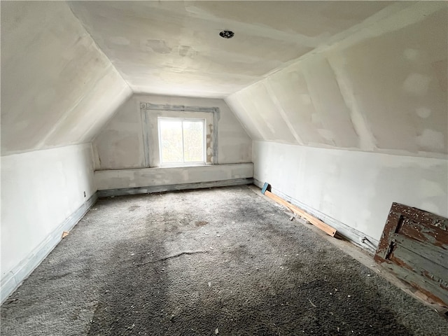 bonus room with lofted ceiling and carpet floors