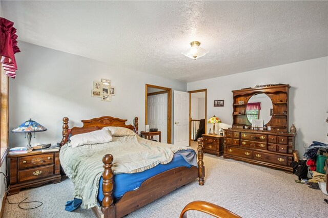 bedroom with carpet flooring and a textured ceiling