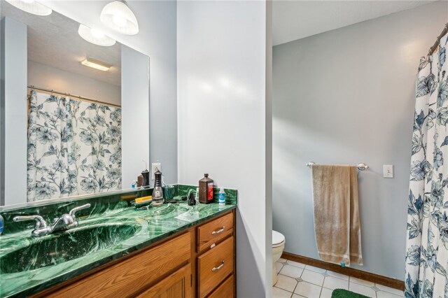 bathroom with vanity, toilet, and tile patterned floors