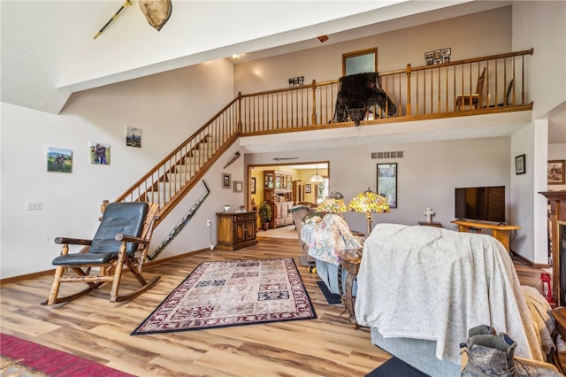 living room with hardwood / wood-style flooring and a high ceiling