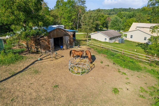 view of yard featuring a rural view and an outbuilding