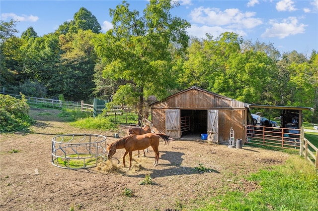 view of horse barn featuring a rural view