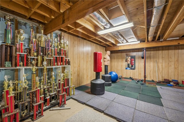 basement featuring wood walls