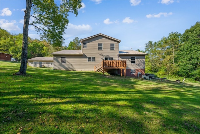 back of property featuring a yard and a wooden deck