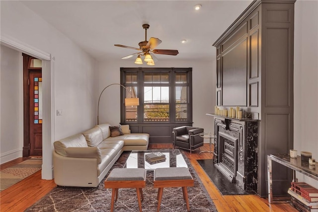 110 Pius St, South Side, PA 15203 - living area with ceiling fan, wood finished floors, baseboards, recessed lighting, and a fireplace with flush hearth