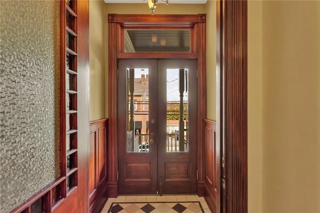 110 Pius St, South Side, PA 15203 - doorway with french doors, a decorative wall, and wainscoting