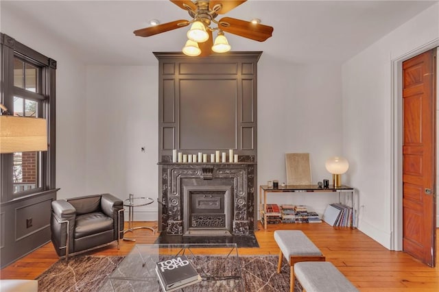 110 Pius St, South Side, PA 15203 - living area featuring hardwood / wood-style floors, ceiling fan, a fireplace, and baseboards