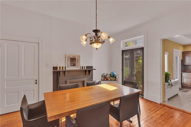 110 Pius St, South Side, PA 15203 - dining space featuring a chandelier, light wood finished floors, and french doors
