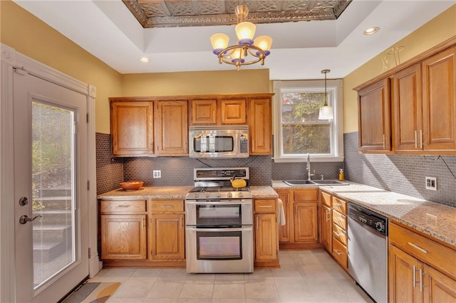 110 Pius St, South Side, PA 15203 - kitchen with appliances with stainless steel finishes, a raised ceiling, a sink, a chandelier, and recessed lighting