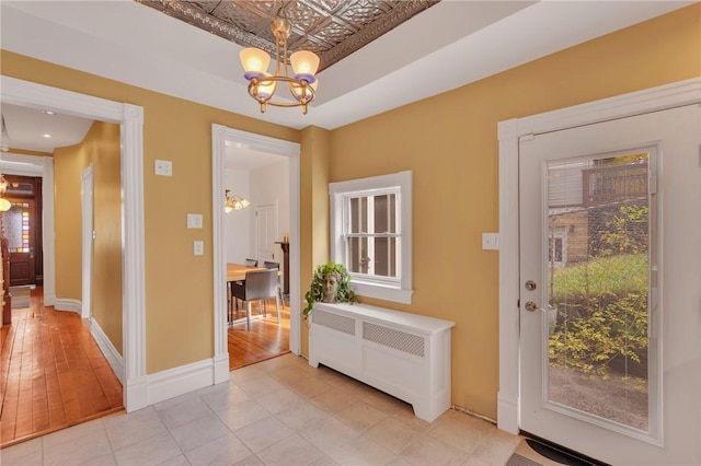 110 Pius St, South Side, PA 15203 - foyer entrance featuring a chandelier, a raised ceiling, baseboards, and light tile patterned floors
