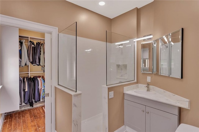 110 Pius St, South Side, PA 15203 - full bath with vanity, a walk in shower, a walk in closet, and wood finished floors