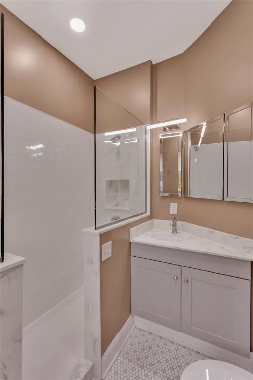 110 Pius St, South Side, PA 15203 - bathroom with a walk in shower, vanity, and tile patterned floors
