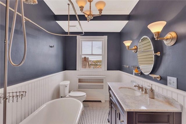 110 Pius St, South Side, PA 15203 - full bath with wainscoting, a soaking tub, vanity, toilet, and tile patterned floors
