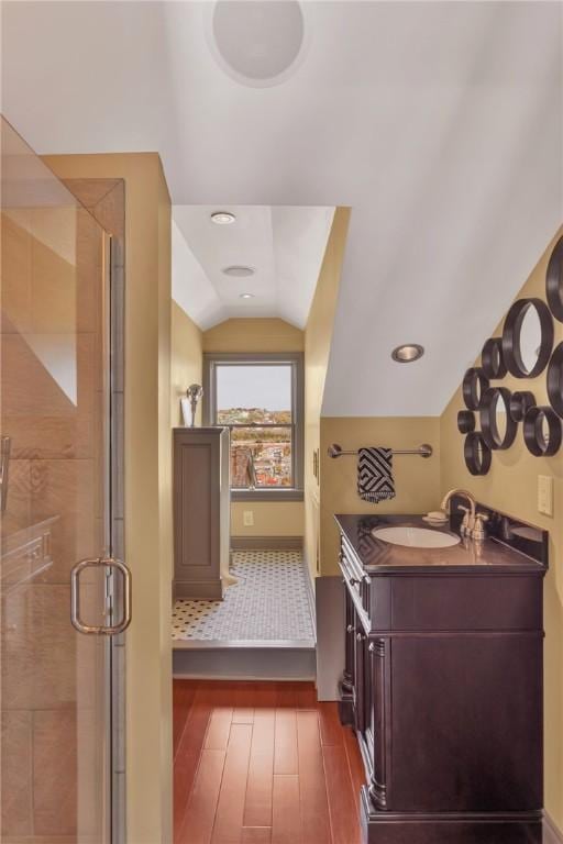 110 Pius St, South Side, PA 15203 - full bathroom featuring lofted ceiling, hardwood / wood-style floors, vanity, baseboards, and a stall shower