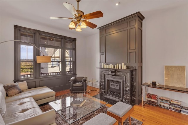 110 Pius St, South Side, PA 15203 - living area with a fireplace with flush hearth, wood finished floors, and ceiling fan