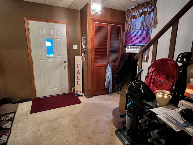 foyer with a drop ceiling and cooling unit