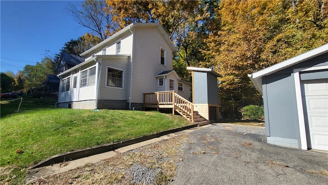 view of side of property with a garage and a lawn