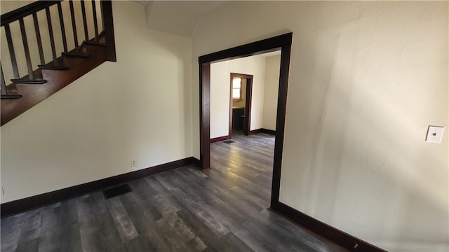 hallway with dark wood-type flooring