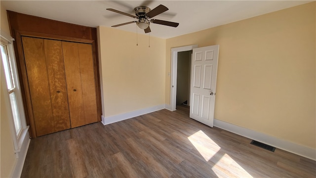 unfurnished bedroom with a closet, ceiling fan, and hardwood / wood-style flooring