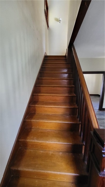 stairway featuring wood-type flooring