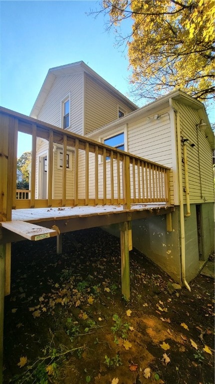 rear view of house featuring a deck