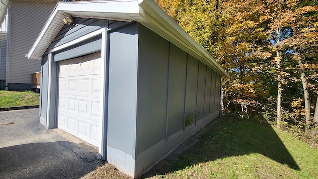 view of side of home featuring a yard and a garage