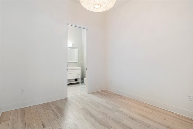 spare room featuring light hardwood / wood-style floors