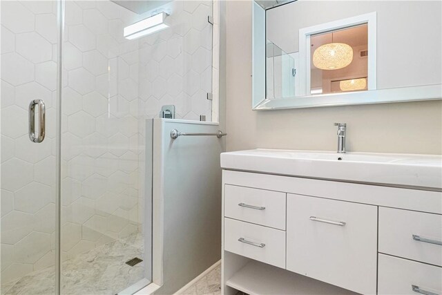 bathroom featuring vanity and a shower with door