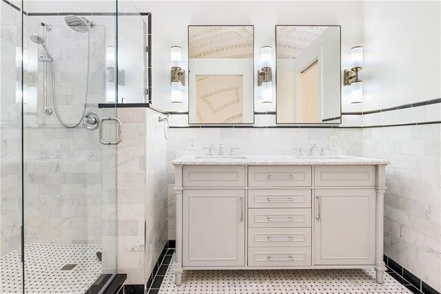 bathroom with tile walls, vanity, and walk in shower