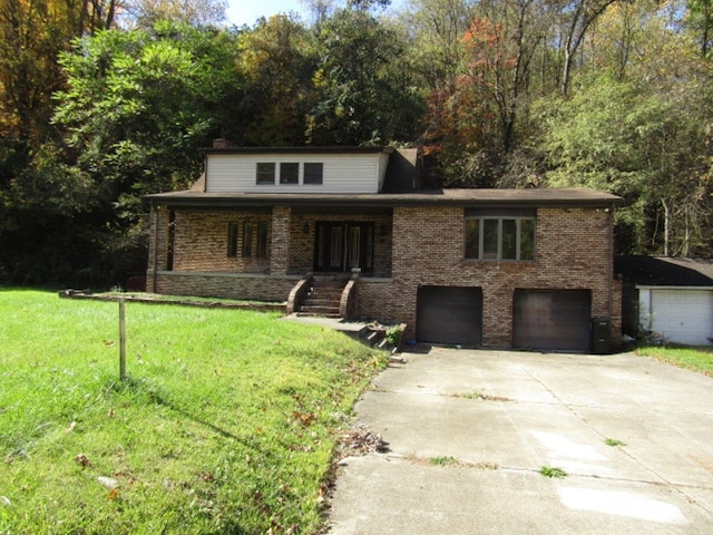 view of front of property with a front lawn and a garage