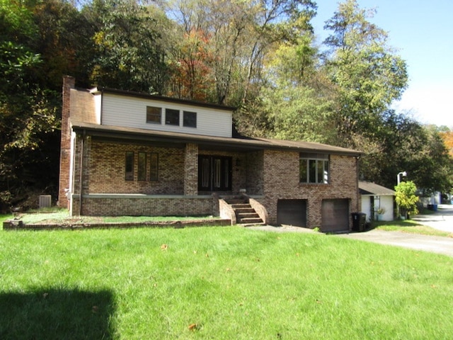 view of front facade featuring covered porch, a front lawn, and a garage