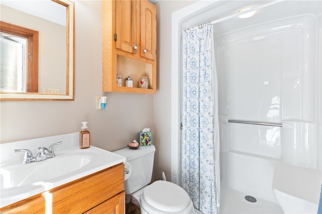 bathroom featuring vanity, toilet, and walk in shower