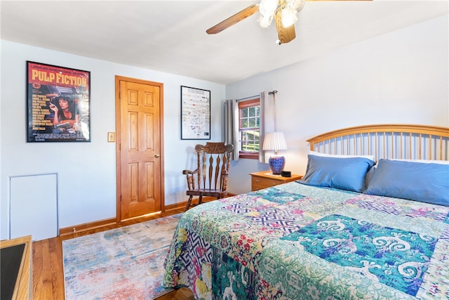 bedroom with ceiling fan and hardwood / wood-style floors