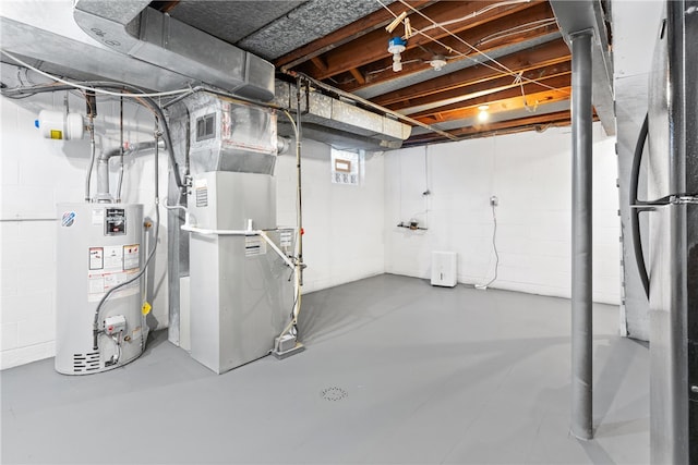 basement featuring stainless steel fridge, gas water heater, and heating unit