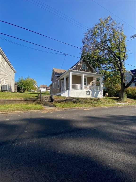 view of front facade featuring central AC unit and covered porch