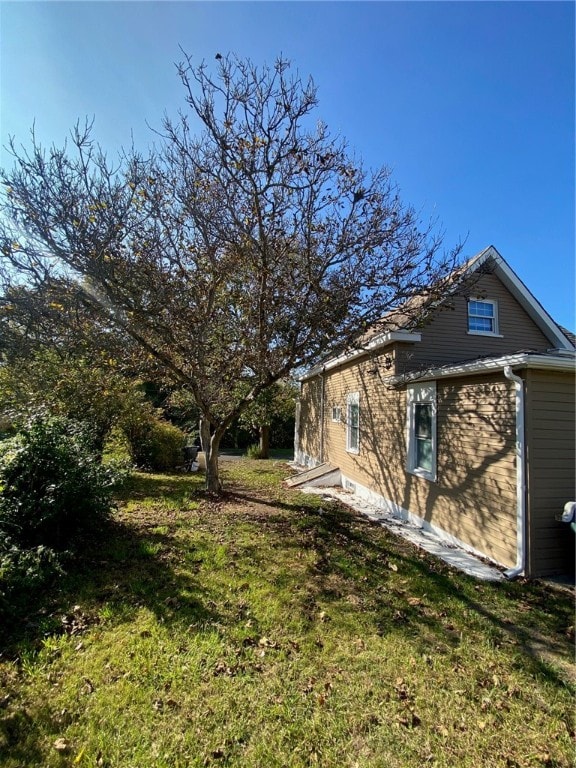 view of home's exterior featuring a yard