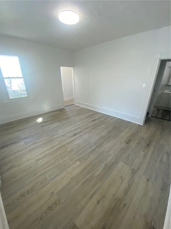 spare room with hardwood / wood-style floors