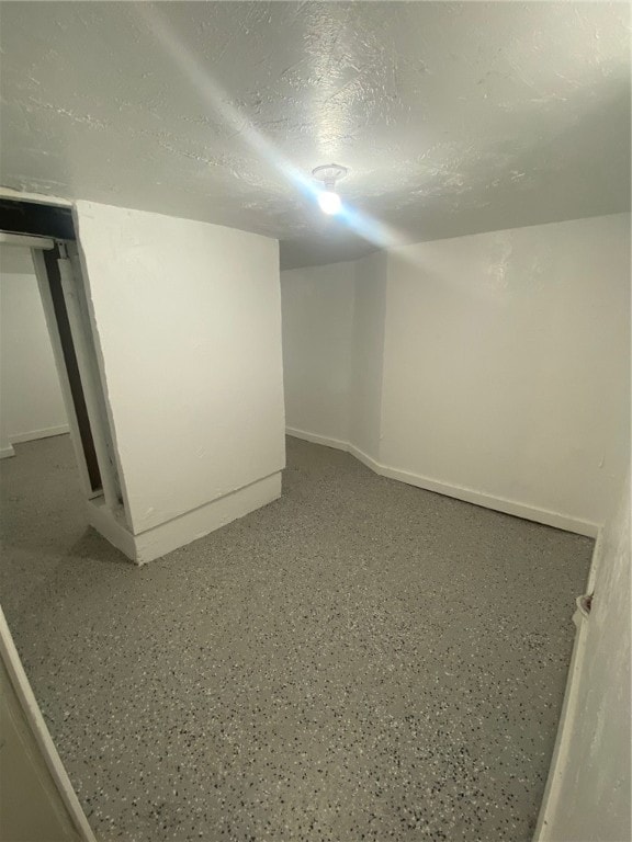 basement featuring a textured ceiling