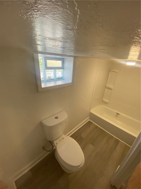 bathroom with hardwood / wood-style floors and toilet