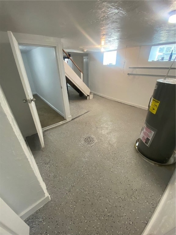 basement with water heater and plenty of natural light