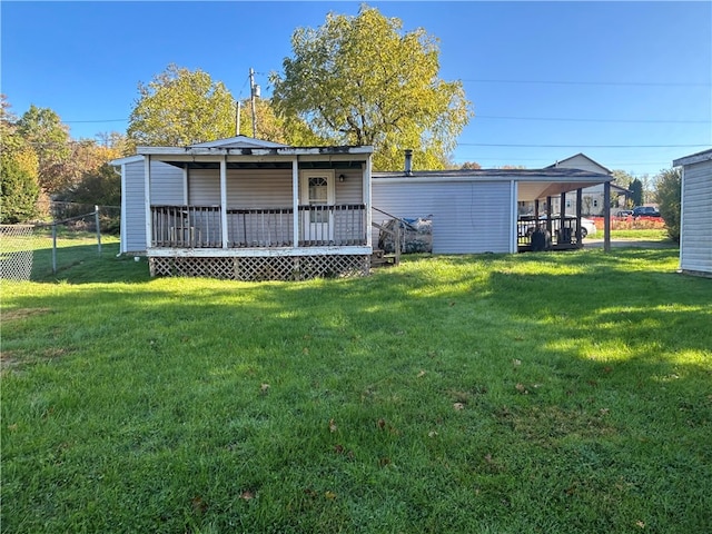 view of yard with a deck and a carport