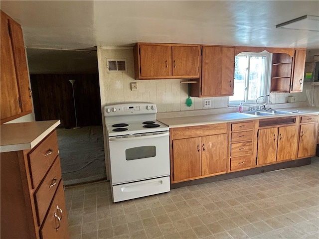 kitchen with electric stove and sink