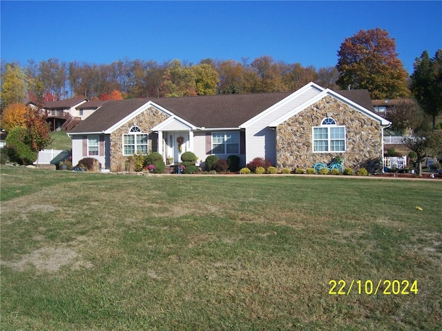 ranch-style home featuring a front yard