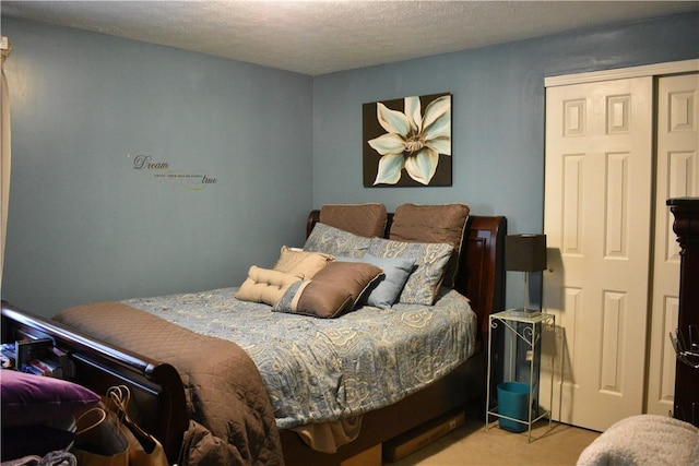 carpeted bedroom featuring a textured ceiling