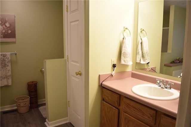 bathroom with vanity and wood-type flooring