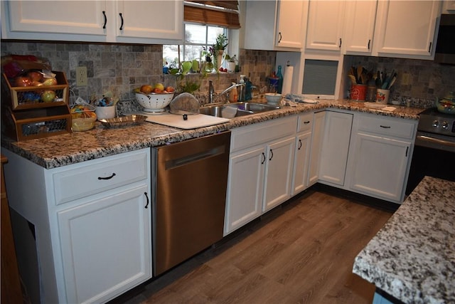 kitchen with white cabinetry, dark hardwood / wood-style flooring, light stone countertops, and appliances with stainless steel finishes